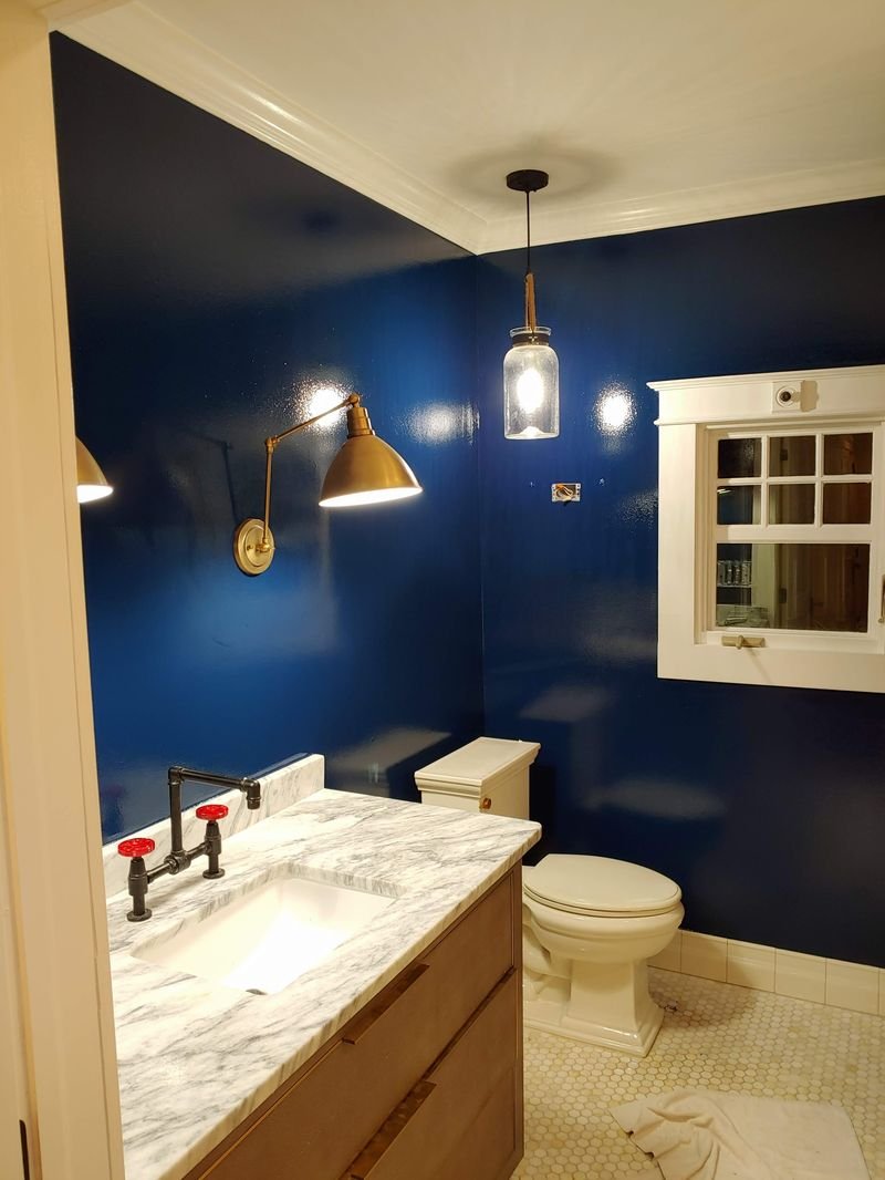 Navy bathroom with marble vanity during construction