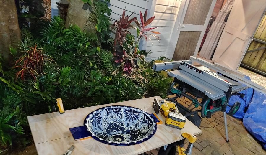 Hand-painted talavera sink being fitted to a tile top